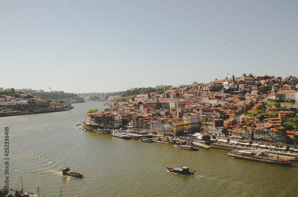 Beautiful Porto cityscape with river and boats