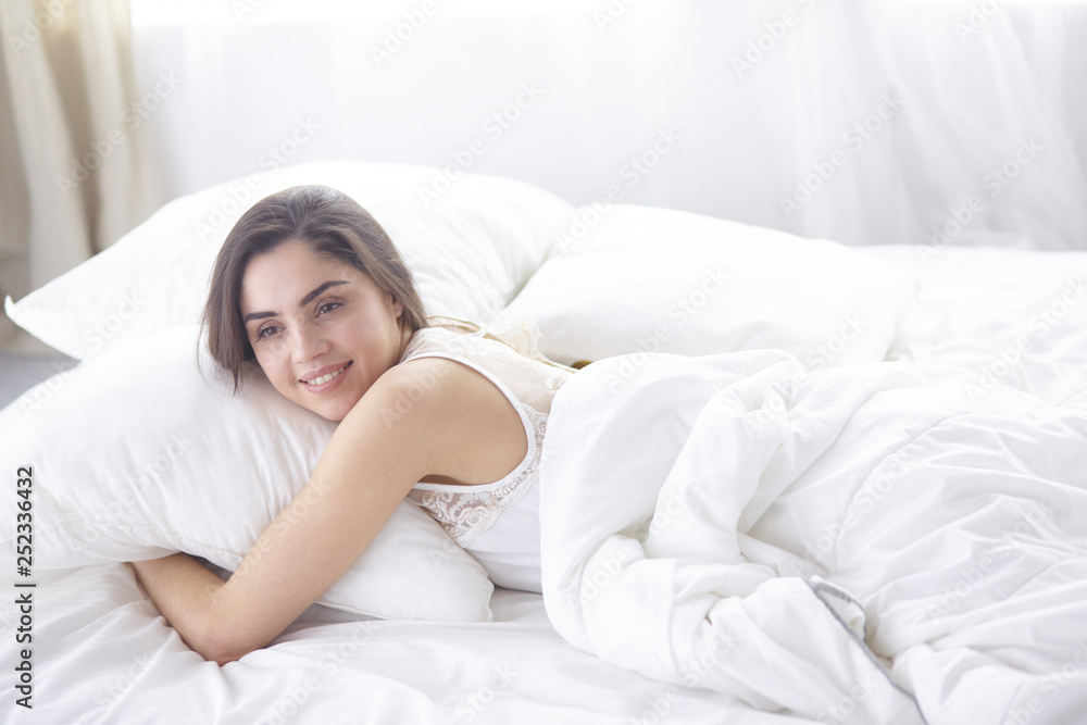 beautiful young woman basking in bed in the morning. Beautiful Model face looks sexy in camera beautiful young woman basking in bed in the morning. Beautiful Model face looks sexy in camera