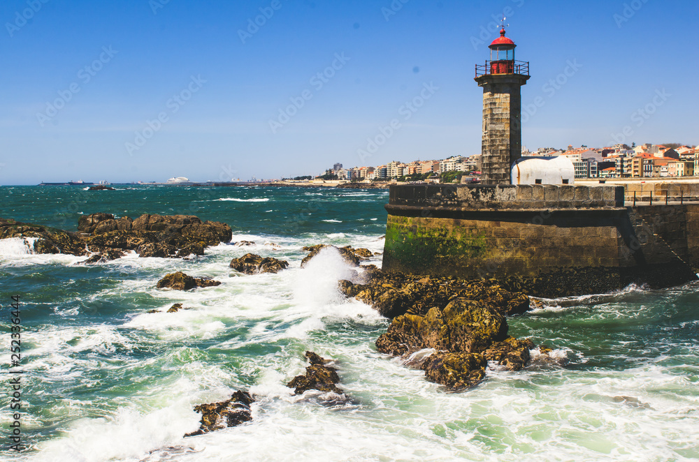 Old stone lighthouse and ocean view in Porto, Portugal