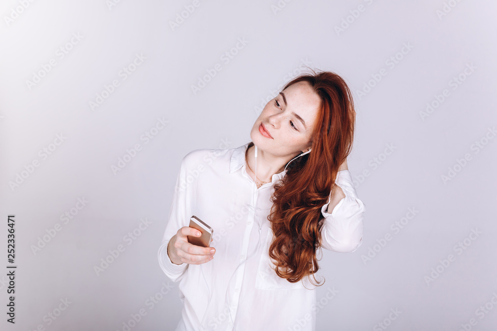 Young woman with smartphone do shopping, connecting with internet, listening to music, learning. Student girl on white background. Education, technology concept Young woman with smartphone do shopping, connecting with internet, listening to music, learning. Student girl on white background. Education, technology concept