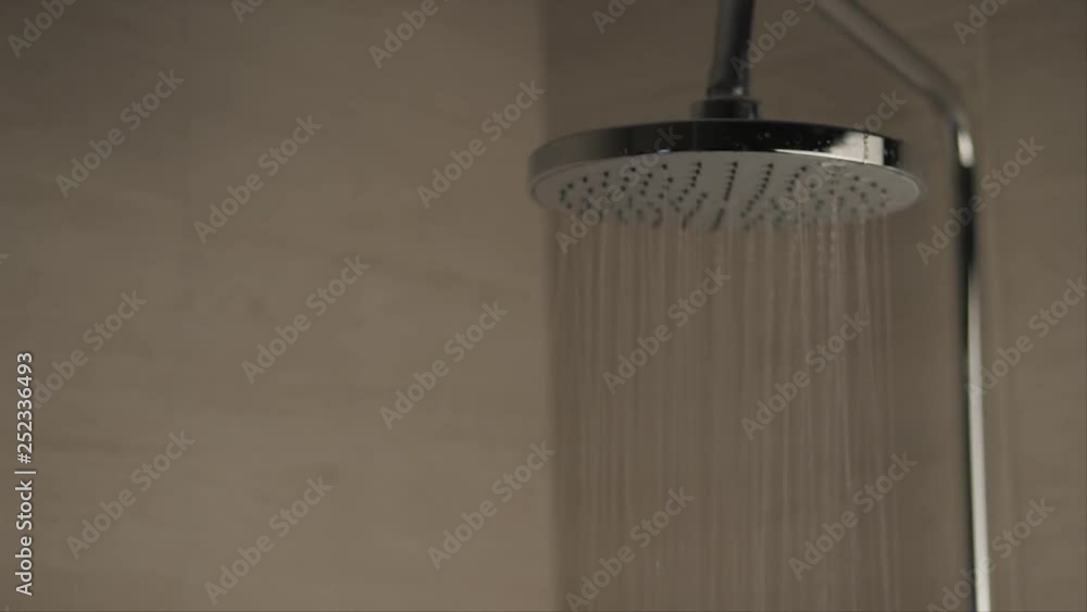 Woman in shower in swimsuit, shallow depth of field. Slow motion Woman in shower in swimsuit, shallow depth of field. Slow motion