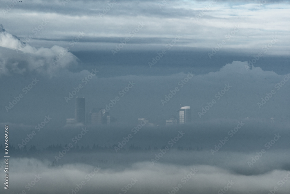 Seattle above a river of clouds and surrounded by dense morning mist in winter