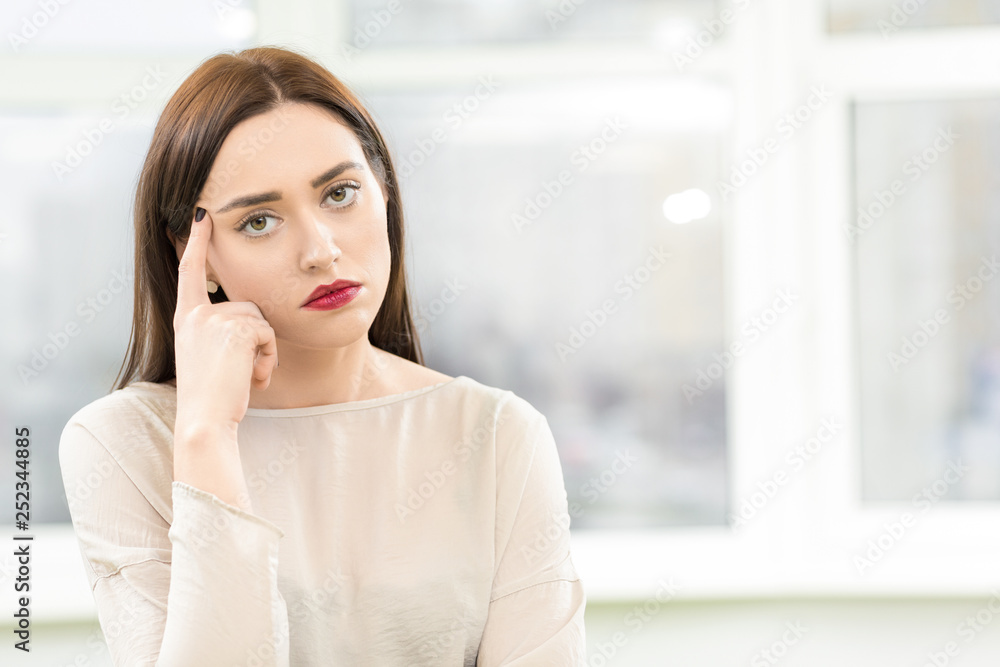 Young beautiful businesswoman looking tired