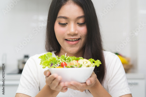 Fresh organic foods. Girl holding salad on bowl.