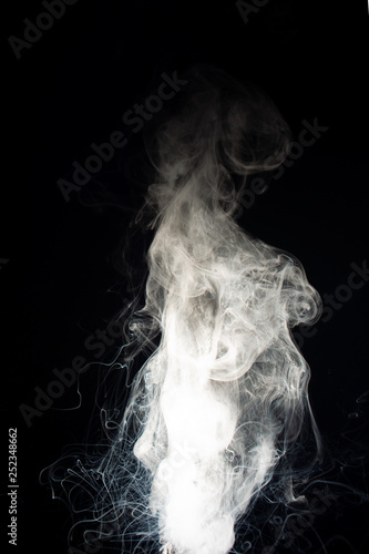 Fototapeta Naklejka Na Ścianę i Meble -  Column of vape clouds splash on black background. A lot of lines of smoke. White fog is tight. Stock isolated white smoke with spray boiling liquid.