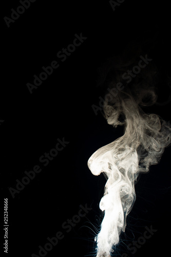 Fototapeta Naklejka Na Ścianę i Meble -  Vape steam column with spray boiling liquid. Stock photo isolated on black background.