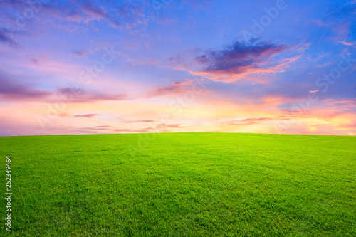 Green grass and beautiful sky at sunset