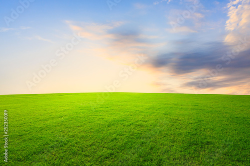 Green grass and beautiful sky at sunset