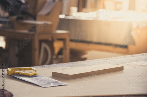 Metal saw for wood on carpenter workbench. Carpentry workshop. Carpenter tools. Sawdust. DIY concept