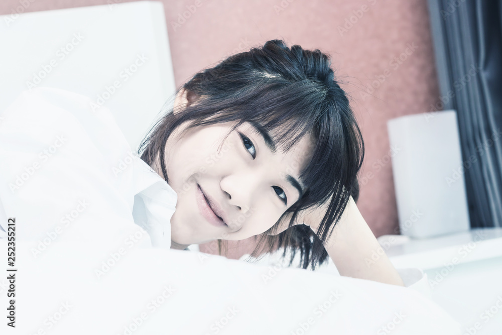 Asian woman wake up on bed in bedroom in the morning.at home in holiday. Asian woman wake up on bed in bedroom in the morning.at home in holiday.