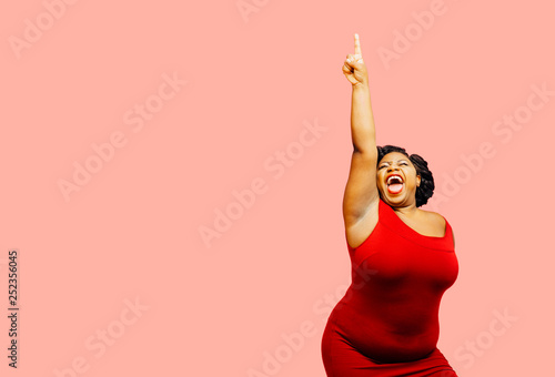 Fototapeta Horizontal portrait of a very happy and excited woman celebrating success with a