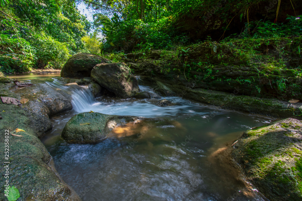 The river flows against the background of rock