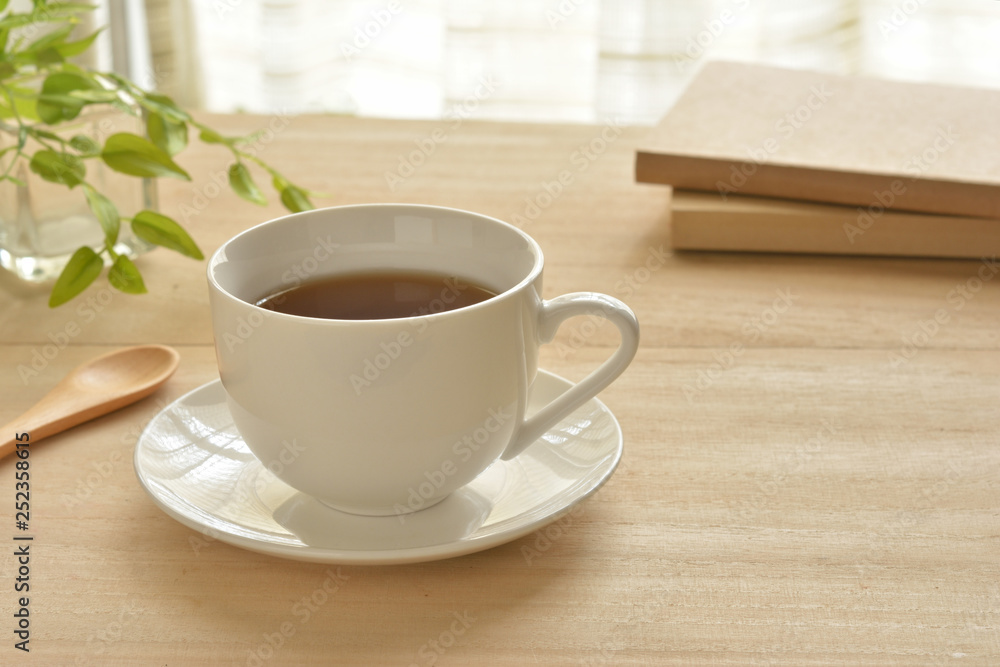 Fototapeta premium A cup of coffee on a wood table
