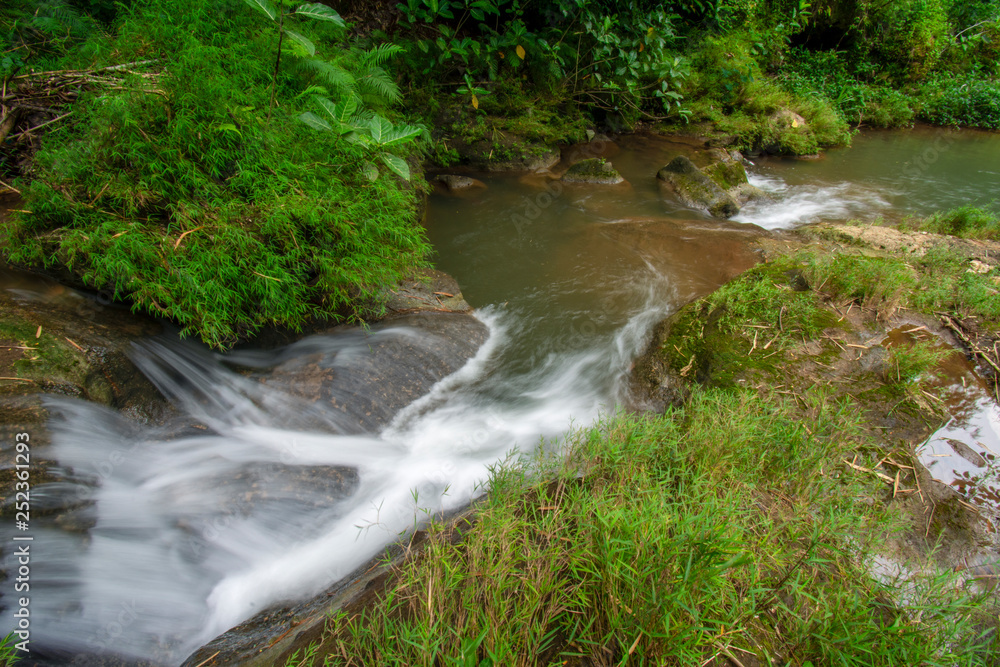 The river flows against the background of rock