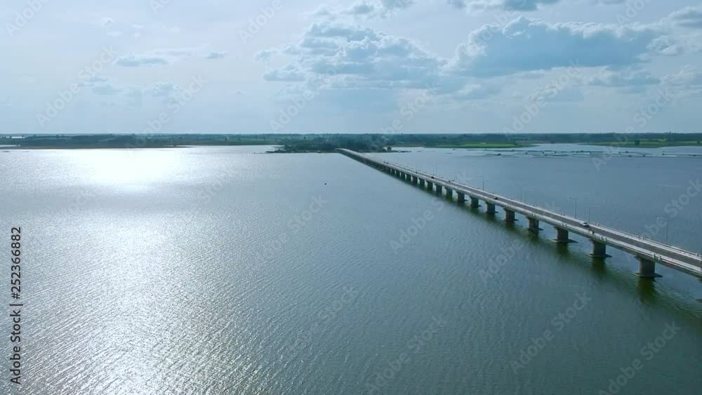 Aerial view Thepsuda Bridge over Lampao Reservoir.Thep Sada Bridge the Deja Vu Bridge is a 2-lane reinforced concrete bridge across Lam Pao Dam at Kalasin,Thailand. Aerial view Thepsuda Bridge over Lampao Reservoir.Thep Sada Bridge the Deja Vu Bridge is a 2-lane reinforced concrete bridge across Lam Pao Dam at Kalasin,Thailand.