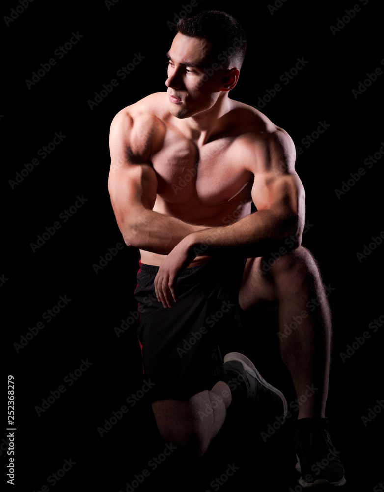 Young strong man isolated