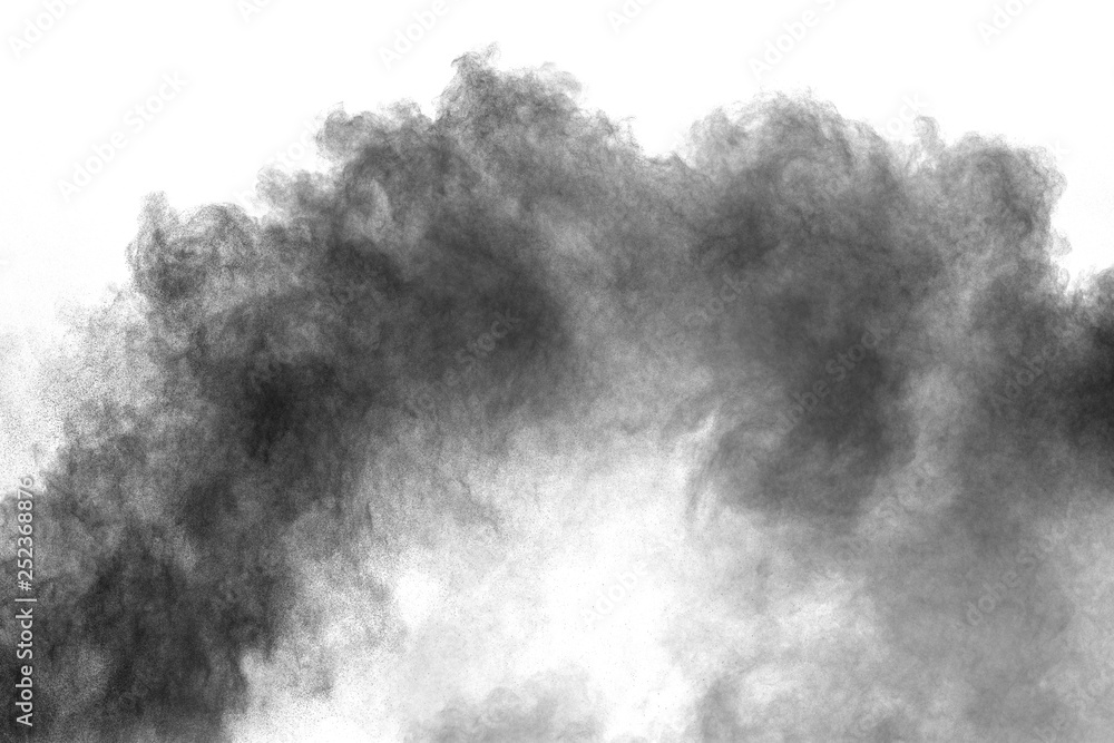 Black powder explosion against white background. Charcoal dust particles exhale in the air. Black powder explosion against white background. Charcoal dust particles exhale in the air.