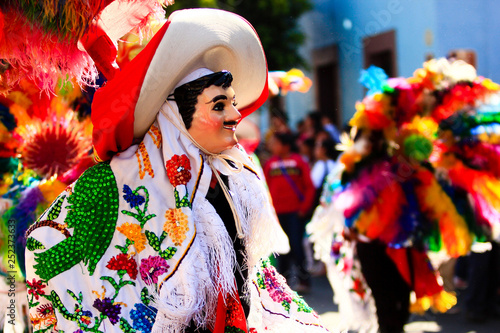 a huehue mexican carnival dancer dancing with a colorful folk costume photo