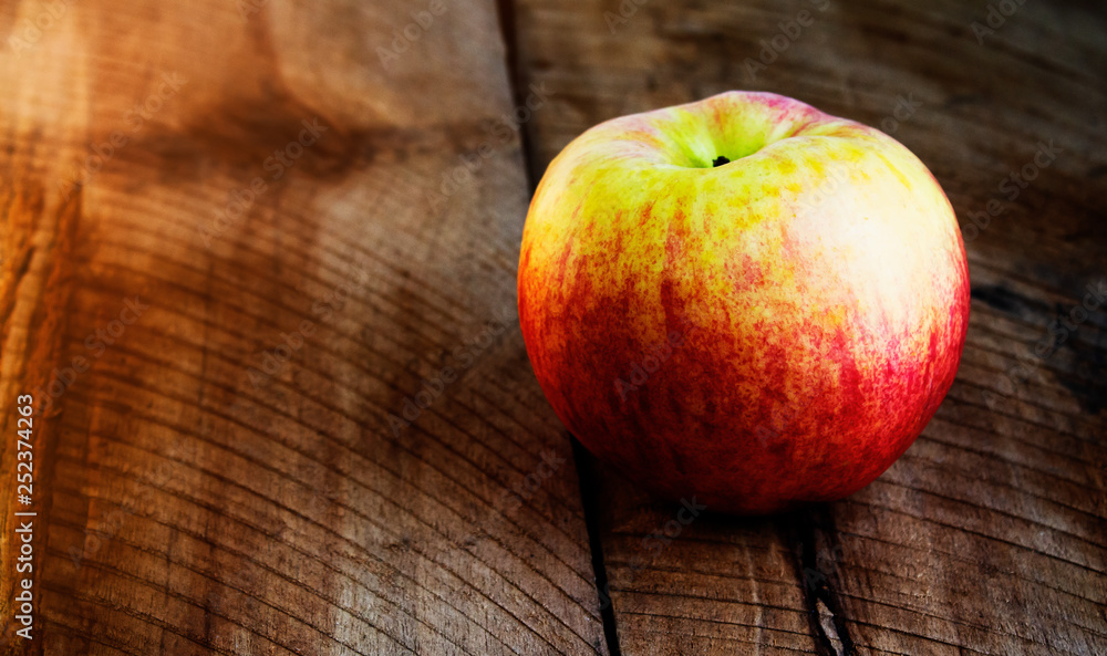 Red apple isolated on wooden table, closeup. Red apple isolated on wooden table, closeup.