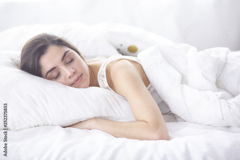 beautiful young woman basking in bed in the morning. Beautiful Model face looks sexy in camera beautiful young woman basking in bed in the morning. Beautiful Model face looks sexy in camera