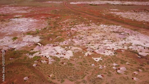 Aerial drone shot of opal mines and mining tailings in the desert outback of Coober Pedy Australia. photo