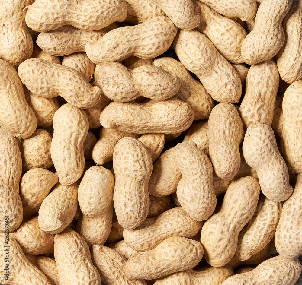 Unshelled peanut background close-up. Top view. Unshelled peanut background close-up. Top view.