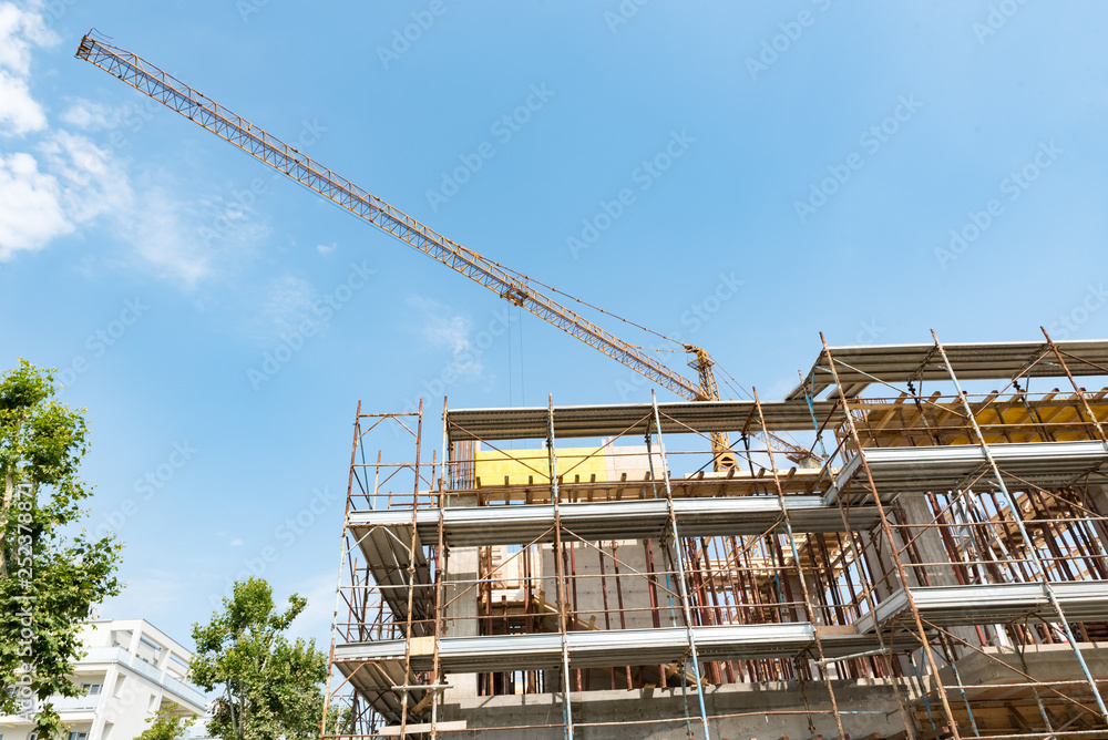 Scaffolds and cranes in a construction site Scaffolds and cranes in a construction site