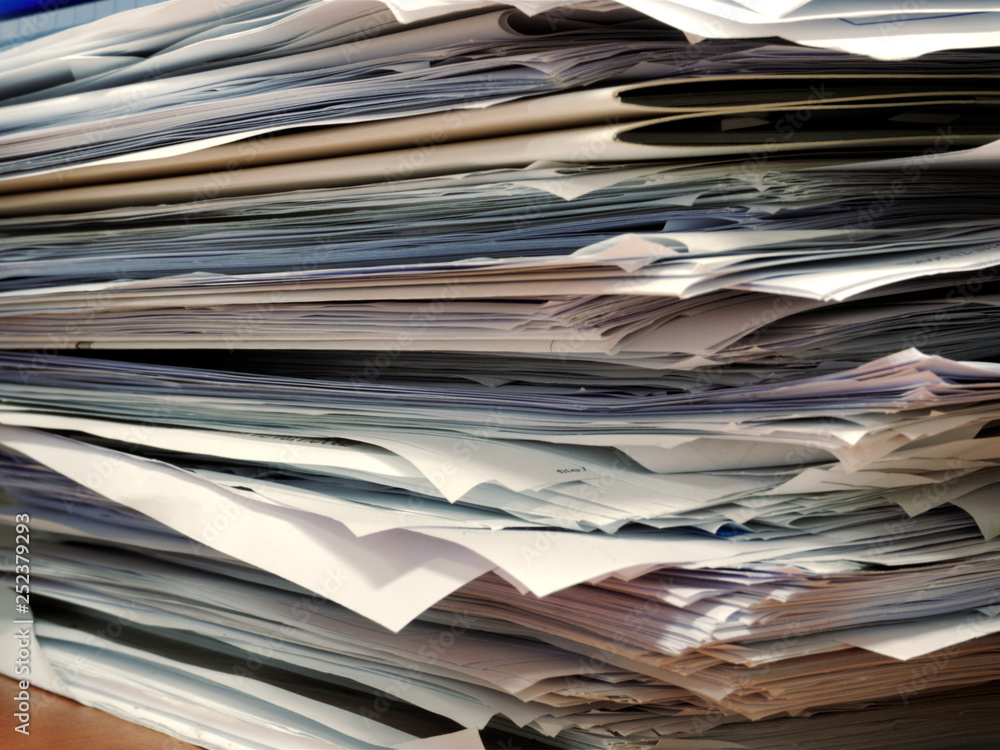 Pile of papers on office desk Pile of papers on office desk