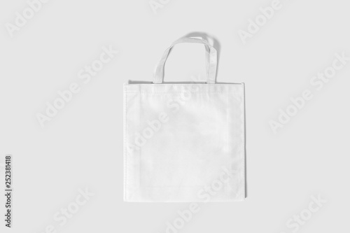 White fabric bag on soft gray background.Tote bag canvas fabric cloth shopping sack mockup blank template.can be used for your design and branding.