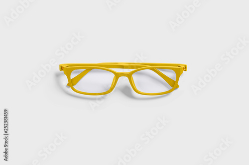 Yellow glasses isolated on soft gray background.
