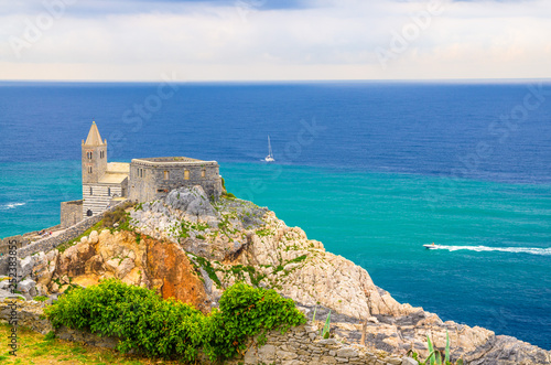 Chiesa San Pietro catholic church, Lord Byron Parque Natural park De Portovenere town on stone cliff rock, yachts on turquoise water of Ligurian sea, Riviera di Levante, La Spezia, Liguria, Italy