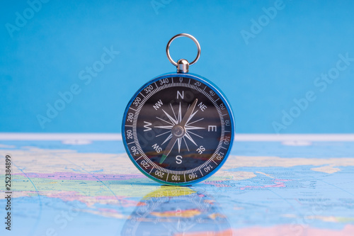 Kuala Lumpur, MALAYSIA FEBRUARY 27, 2019: Compass on world map background. Selective focus