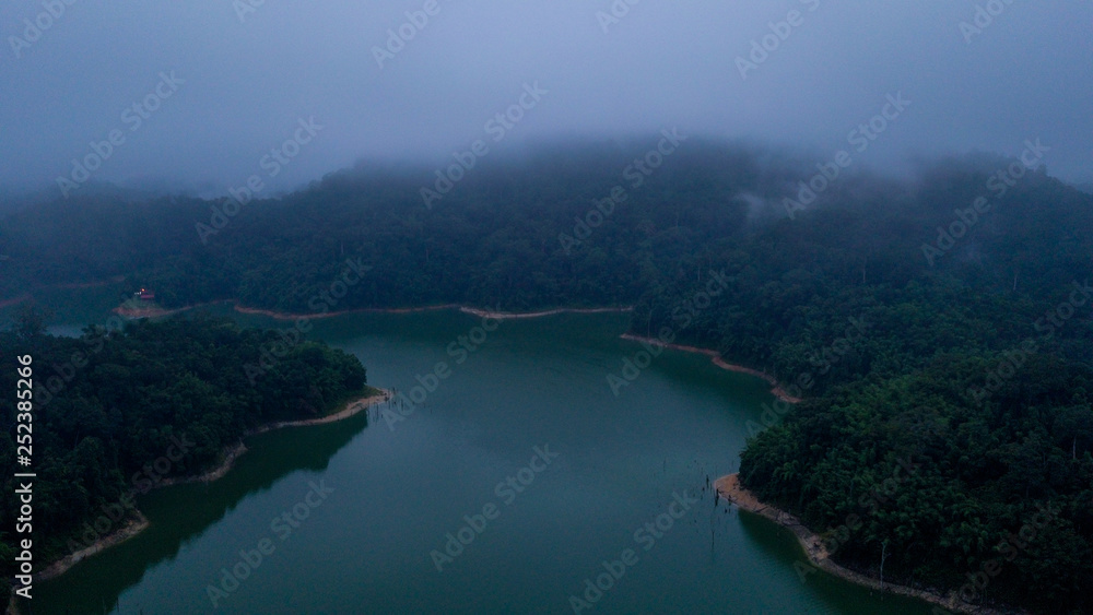 A beautiful landscape of aerial view with the fog surrounding the hill area in Royal Belum Malaysia
