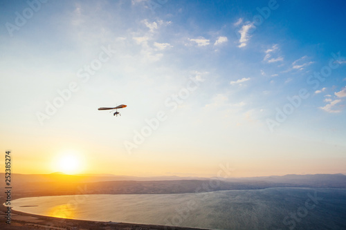 Hang-glider  flight in sky in sunset time over the Kineret, Mevo Hama, Israel photo