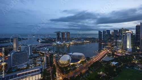 4k time lapse of sunrise night to day at Marina Bay Singapore city skyline. Zoom out photo