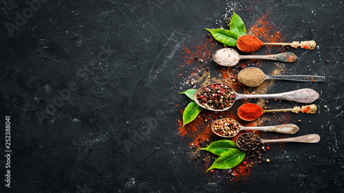 Fototapeta Naklejka Na Ścianę i Meble -  Colored pepper and sea salt. Top view. On the old background. free space for your text.