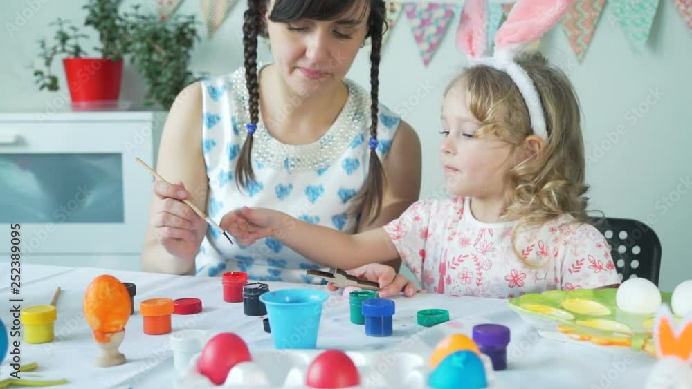 Mother Helping Daughter to Paint Easter Bunny Mother Helping Daughter to Paint Easter Bunny