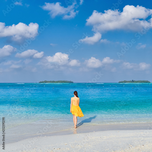 Woman in dress walking on tropical beach © haveseen