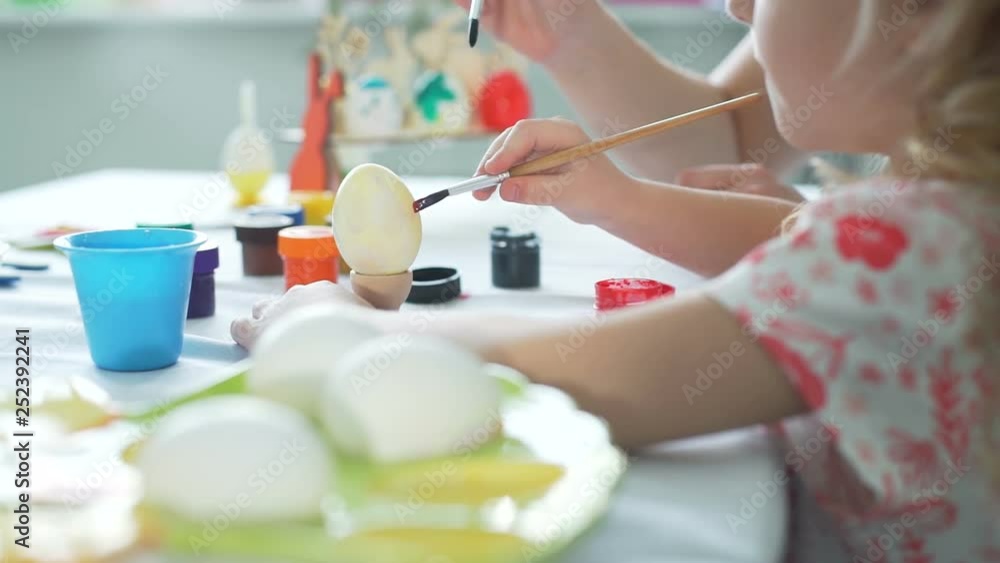 Painting Funny Face on Easter Egg Painting Funny Face on Easter Egg