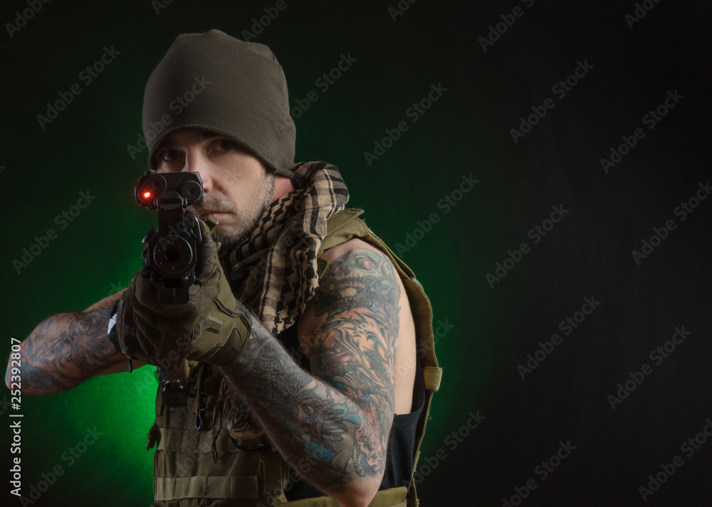 The guy in protective clothing and a black mask with a sniper rifle The guy in protective clothing and a black mask with a sniper rifle