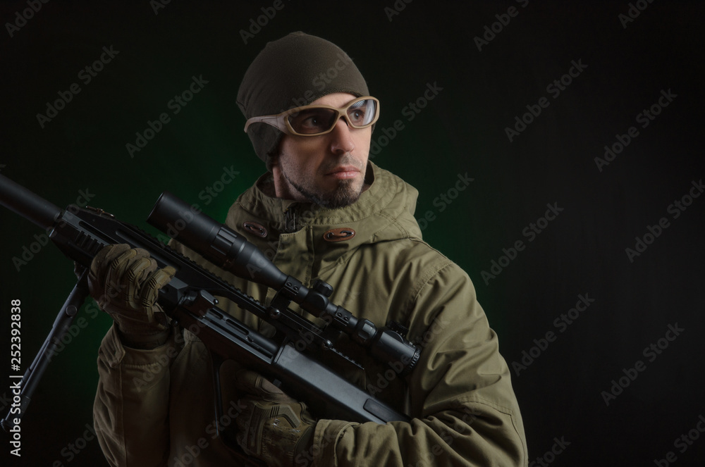 The guy in protective clothing and a black mask with a sniper rifle The guy in protective clothing and a black mask with a sniper rifle