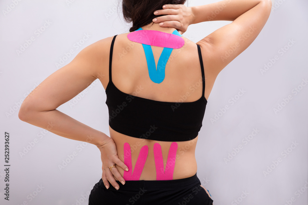 Rear View Of Woman With Physio Tape Rear View Of Woman With Physio Tape