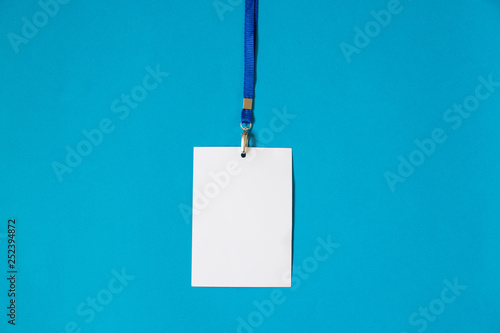 Empty ID card badge icon with blue belt, on blue background. Space for text,  staff identity name tag template.