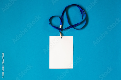 Empty ID card badge icon with blue belt, on blue background. Space for text,  staff identity name tag template.