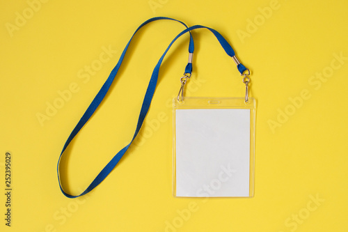Empty ID card badge icon with blue belt, on yellow background. Space for text,  staff identity name tag template.