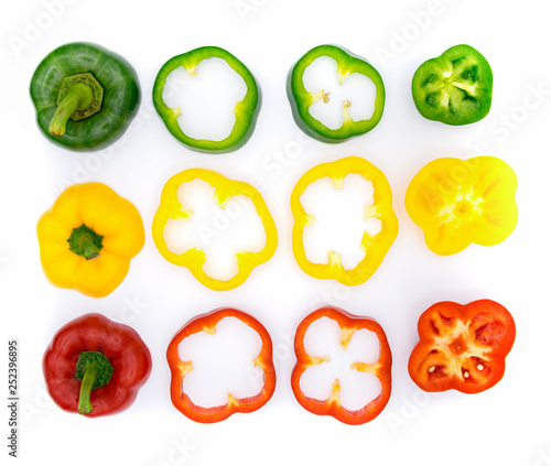 Green, red, yellow pepper, cut into pieces, put together on a white background