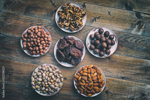 assorted nuts and dried apricots on a wooden background