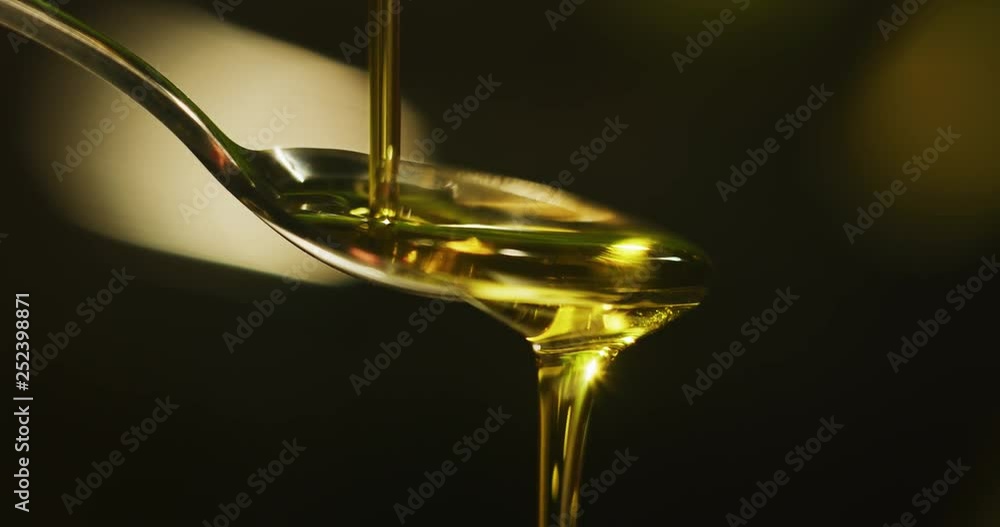 Slow motion macro close up of spoon dosing a biological and ecological hemp plant herbal pharmaceutical cbd oil. Slow motion macro close up of spoon dosing a biological and ecological hemp plant herbal pharmaceutical cbd oil.