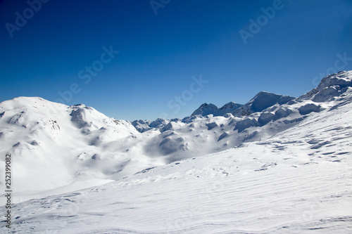 Beautiful Winter Landscape of the Mountain covered with snow under the blue and clear sky and snow field. Ski touring and snoshoeing paradise. Slovenia, Julian Alps, Komna
