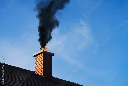 Chimney on fire with a black smoke